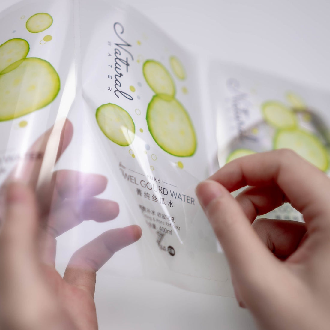 Clear label stickers applied to cosmetic product packaging, transparent product labels