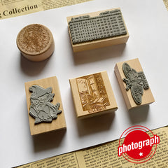 Assorted custom rubber stamps in different shapes on natural wood blocks
