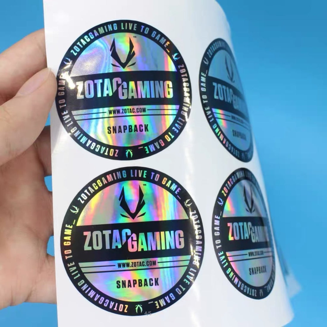 Hand holding a sheet of holographic stickers — Pakvel