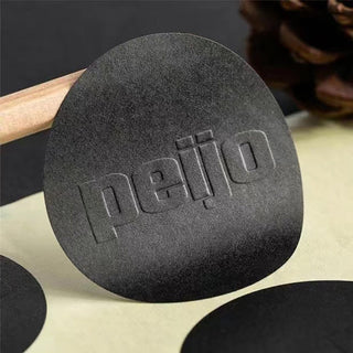 Black debossed custom sticker on a craft scene — Pakvel