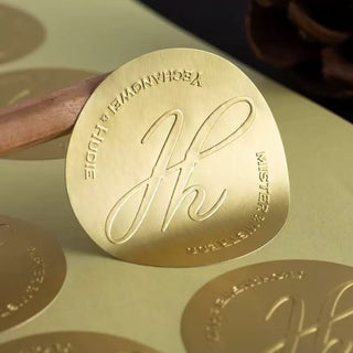 Embossed logo on matte gold metallic stock — Pakvel