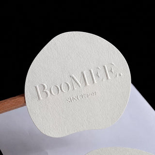 Blind embossed logo on white textured stock — Pakvel