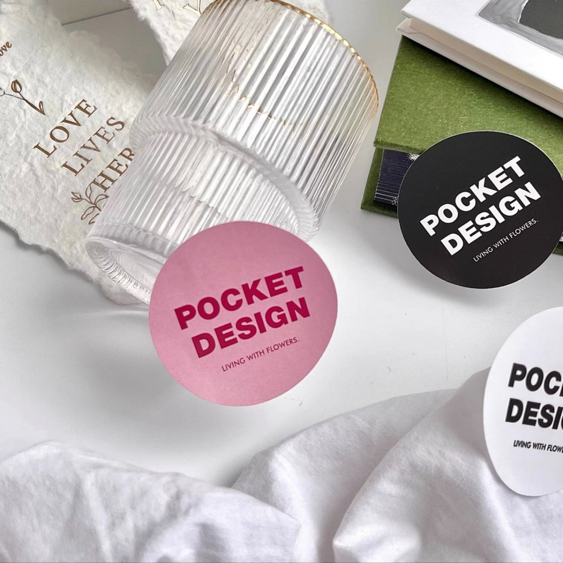 Pink and black round matte paper stickers styled with glassware, matte finish brand stickers