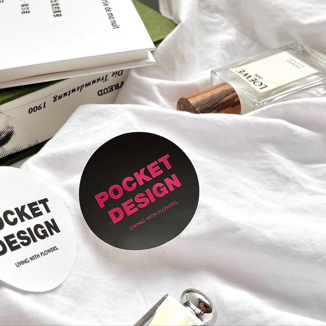 Matte paper round logo stickers in a product flat-lay, soft no-glare matte finish labels