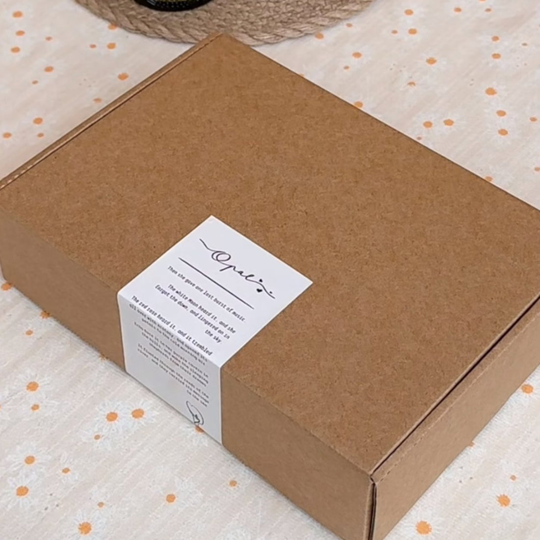 White matte paper rectangle label on a kraft mailer box, soft no-glare matte finish