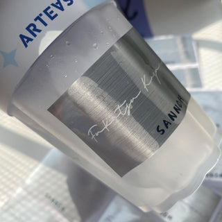 Frosted cup with a brushed silver metallic label band, premium metallic product sticker