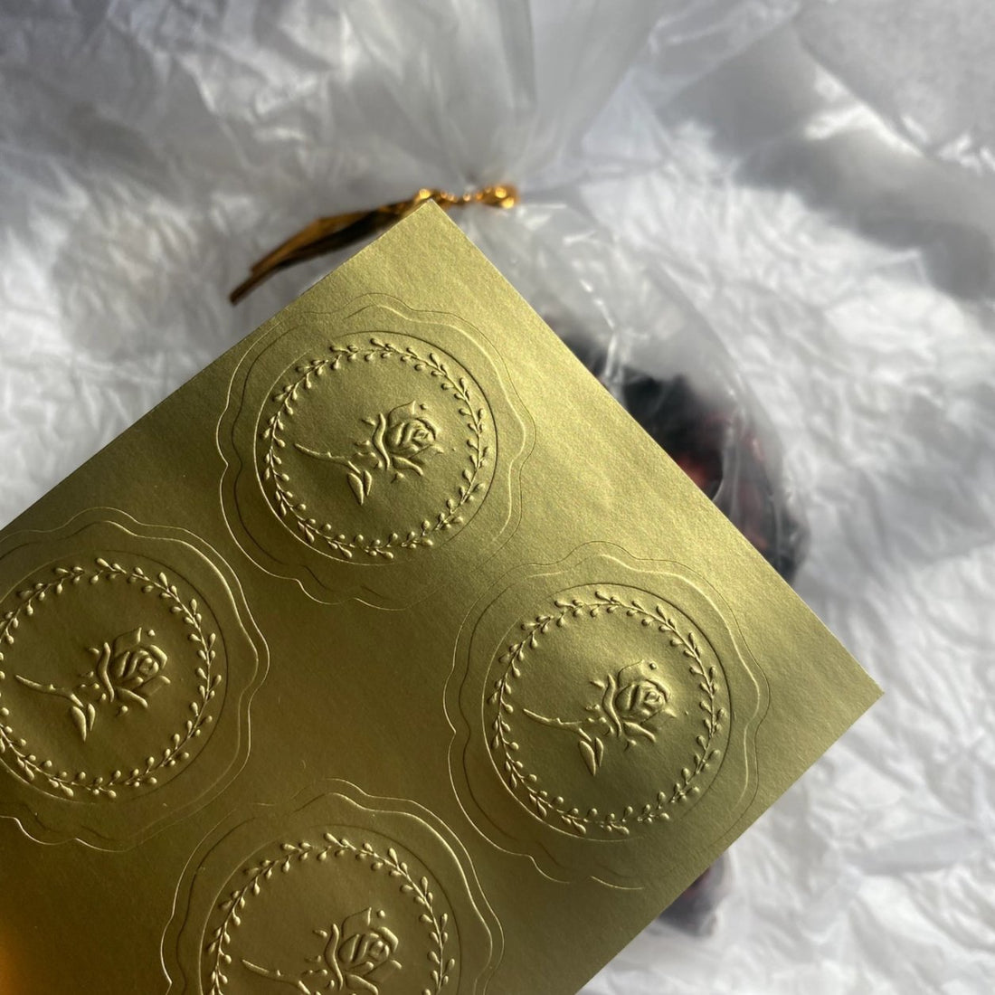 Gold metallic sticker sheet with embossed round crest emblems, raised emboss on gold foil paper