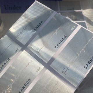 Brushed silver metallic label stickers with elegant script branding, foil paper finish