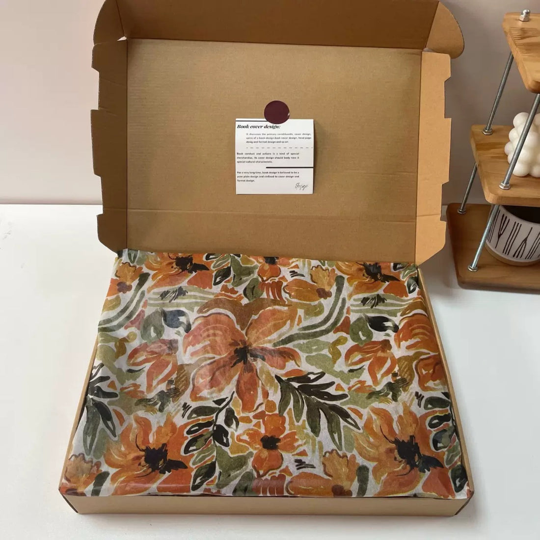 Autumnal painterly floral tissue paper lining a kraft mailer box