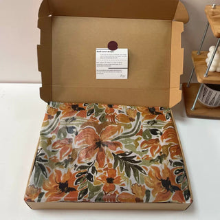 Autumnal painterly floral tissue paper lining a kraft mailer box