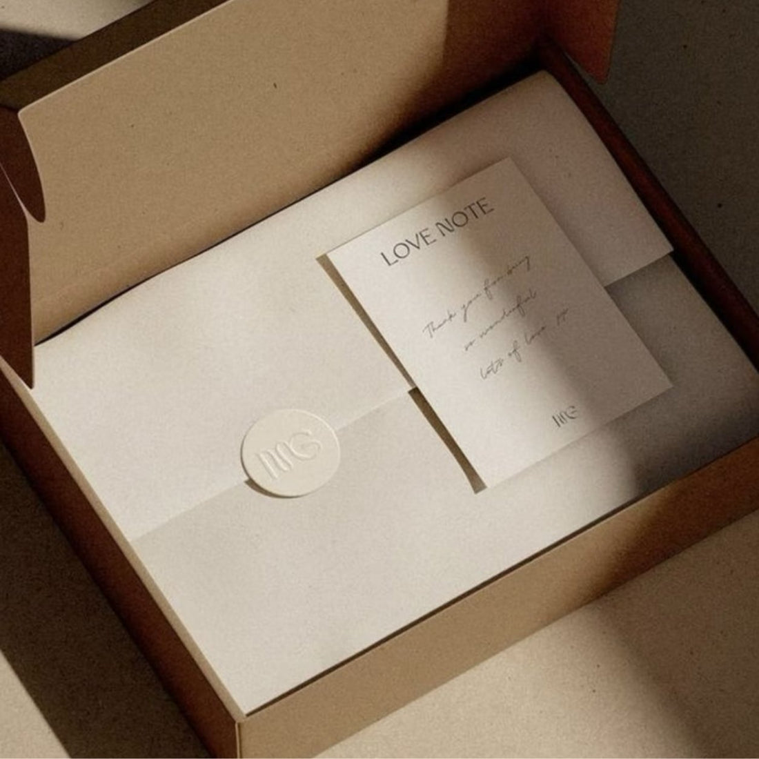 Gift box with a textured paper card and wax seal, premium tactile stationery