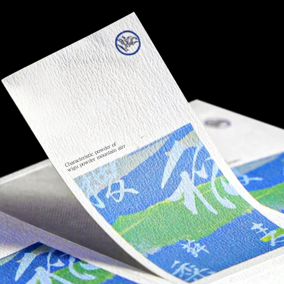 Textured paper card with printed artwork and an embossed logo, felt-finish stationery