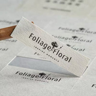 Rectangle textured paper label with an embossed logo, premium felt-finish product label