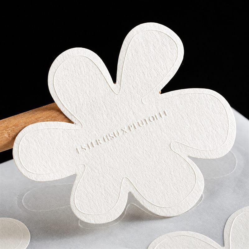 Custom die-cut shape sticker with a decorative edge on textured paper — Pakvel